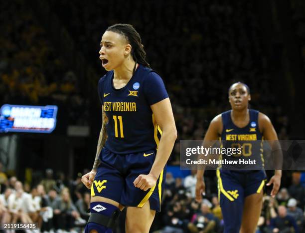Guard J.J. Quinerly of the West Virginia Mountaineers celebrates after a basket in the second half against the Iowa Hawkeyes during their second...