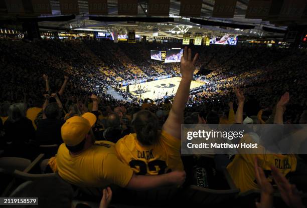 Fans cheer as they watch the game between the Iowa Hawkeyes and the West Virginia Mountaineers during their second round match-up in the 2024 NCAA...