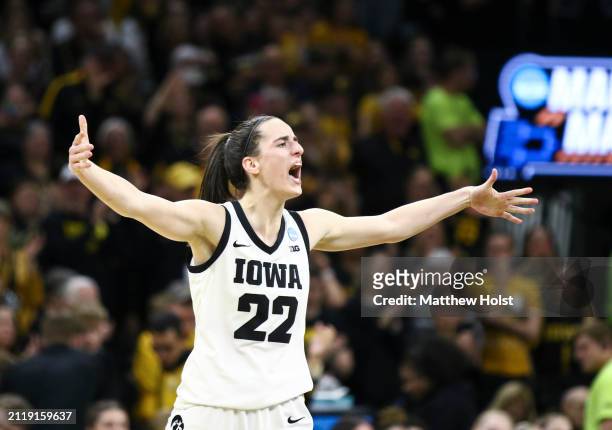 Guard Caitlin Clark of the Iowa Hawkeyes celebrates after drawing a foul late in the second half against the West Virginia Mountaineers during their...