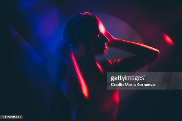 beautiful young woman enjoying music against multicolored background. - neon fluorescent hair stock-fotos und bilder