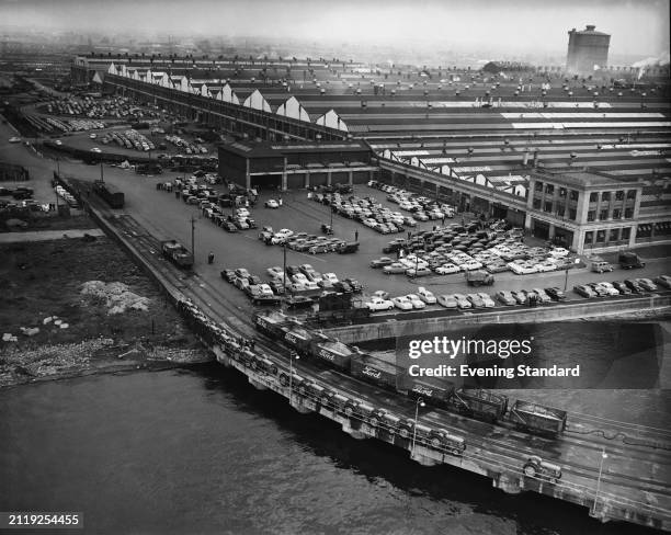 Elevated view of the Ford Motor Company's car plant on the River Thames at Dagenham, October 21st 1953. Hundreds of new cars are parked outside the...