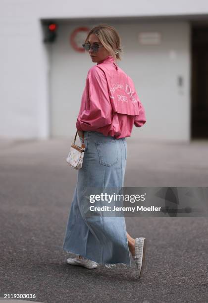 Karin Teigl seen wearing Rhude grey sunglasses, Christian Dior Sports pink vintage jacket, Agolde light blue denim long skirt, Louis Vuitton white...