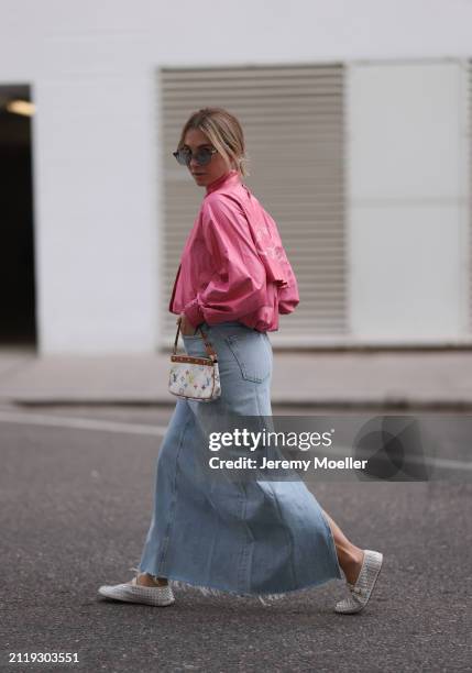 Karin Teigl seen wearing Rhude grey sunglasses, Christian Dior Sports pink vintage jacket, Agolde light blue denim long skirt, Louis Vuitton white...