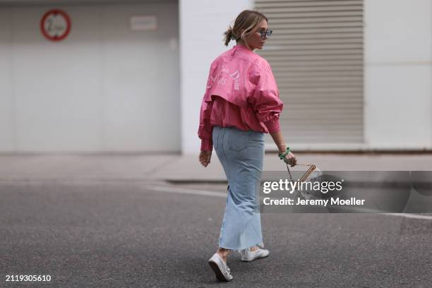 Karin Teigl seen wearing Rhude grey sunglasses, Christian Dior Sports pink vintage jacket, Agolde light blue denim long skirt, Louis Vuitton white...