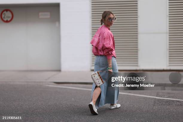 Karin Teigl seen wearing Rhude grey sunglasses, Christian Dior Sports pink vintage jacket, Agolde light blue denim long skirt, Louis Vuitton white...