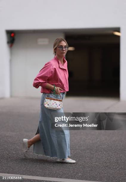 Karin Teigl seen wearing Rhude grey sunglasses, Christian Dior Sports pink vintage jacket, Agolde light blue denim long skirt, Louis Vuitton white...