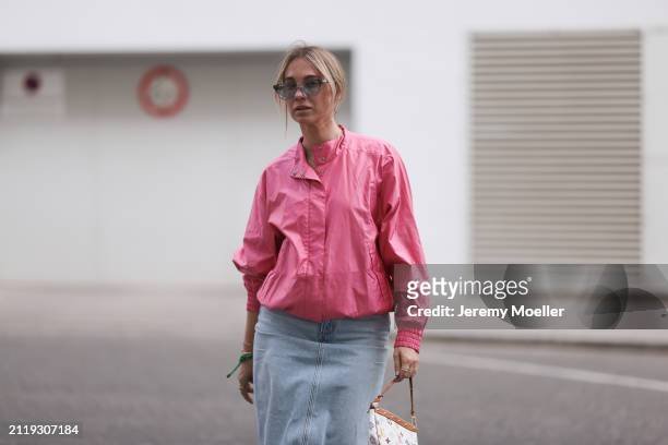 Karin Teigl seen wearing Rhude grey sunglasses, Christian Dior Sports pink vintage jacket, Agolde light blue denim long skirt, Louis Vuitton white...