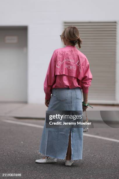 Karin Teigl seen wearing Christian Dior Sports pink vintage jacket, Agolde light blue denim long skirt, Louis Vuitton white canvas with colorful logo...