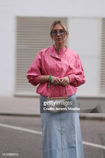 Karin Teigl seen wearing Rhude grey sunglasses, Christian Dior Sports pink vintage jacket, Agolde light blue denim long skirt, Louis Vuitton white...