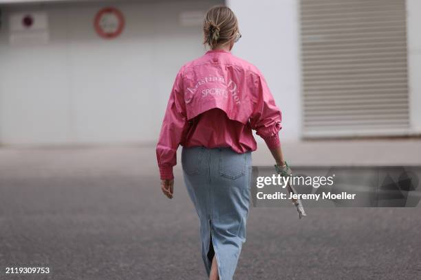 Karin Teigl seen wearing Christian Dior Sports pink vintage jacket, Agolde light blue denim long skirt, Louis Vuitton white canvas with colorful logo...