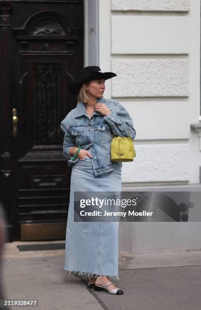 Karin Teigl seen wearing Miu Miu black cowboy hat, Agolde light blue denim jacket, Agolde light blue denim long skirt, Prada Re-edition lime green...