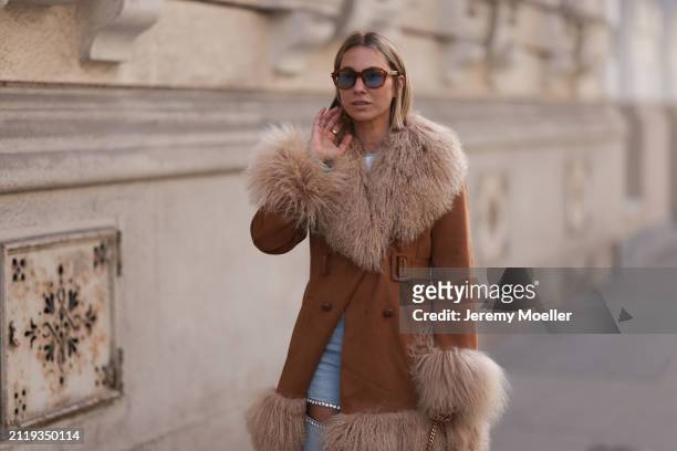 Karin Teigl seen wearing Jacques Marie Mage brown sunglasses with blue lenses, Charlotte Simone brown / beige fluffy fur suede jacket and Aera light...