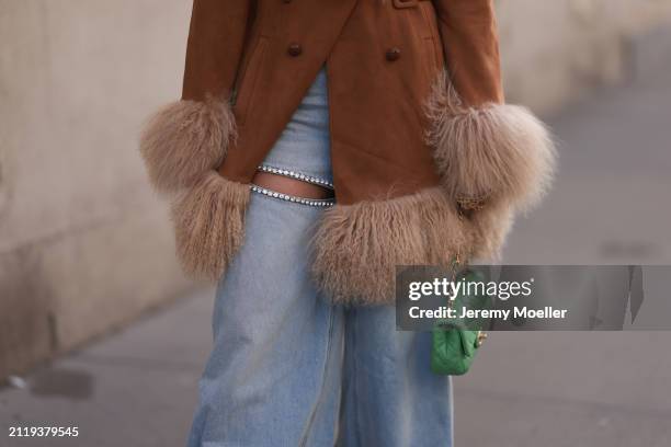 Karin Teigl seen wearing Charlotte Simone brown / beige fluffy fur suede jacket, Aera light blue rhinestones pattern cut-outs wide leg jeans / denim...