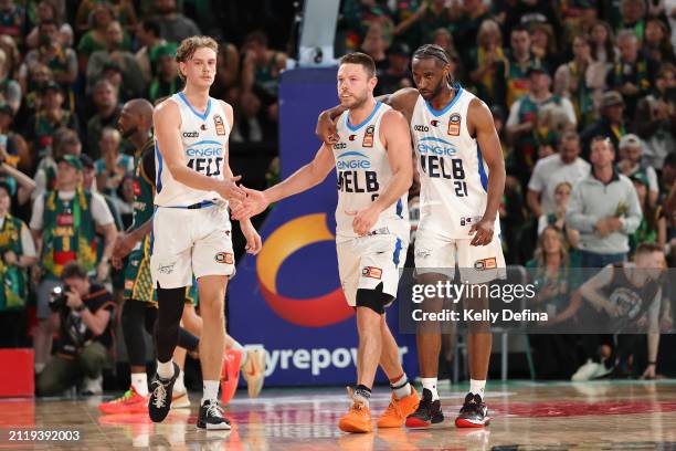 Luke Travers, Matthew Dellavedova and Ian Clark of United celebrate in the final minute after Matthew Dellavedova of United scores during game four...