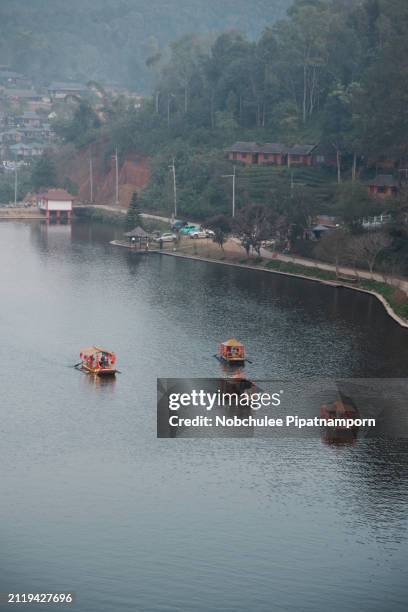 beautiful landscape ban rak thai, mae hong son, thailand, boat on the river . mist rising off the lake - mae hong son province stock pictures, royalty-free photos & images