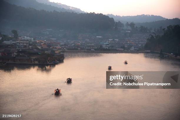 beautiful sunrise behind the hill at ban rak thai, ban rak thai a chinese settlement, mae hong son, thailand. - mae hong son province stock pictures, royalty-free photos & images