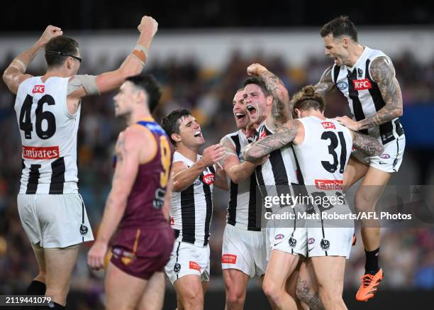 Jack Crisp of the Magpies celebrates kicking a goal with team mates during the round 3 AFL match between the Brisbane Lions and Collingwood Magpies...