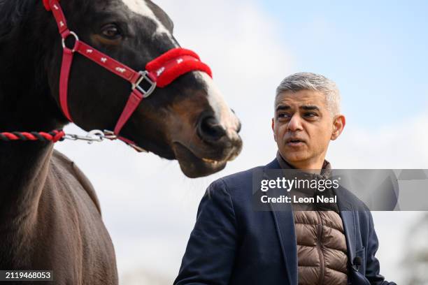 Mayor of London Sadiq Khan stands with a horse at the Strength and Learning through Horses equine therapy centre at Green Gates stables on March 28,...