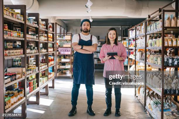 japanese organic convenience store owners stand side by side, exuding confidence and positivity - exuding stock pictures, royalty-free photos & images