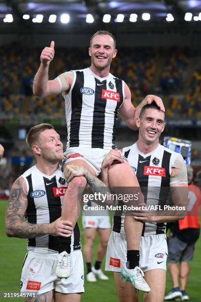 Tom Mitchell of the Magpies is chaired from the field after his 200th match during the round 3 AFL match between the Brisbane Lions and Collingwood...