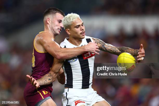 Bobby Hill of the Magpies is tackled during the round three AFL match between Brisbane Lions and Collingwood Magpies at The Gabba, on March 28 in...