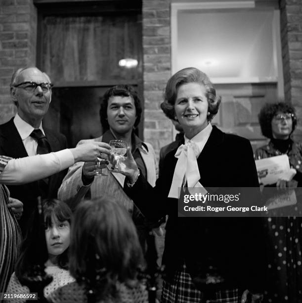 Margaret Thatcher, Conservative politician, and Leader of the Opposition, toasting an exhibit during a preview of The Ideal Home Exhibition at Earl's...