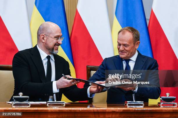 Poland's Prime Minister, Donald Tusk and Ukraine's Prime Minister, Denys Shmyhal sign documents after bilateral meetings at the Chancellery of Prime...