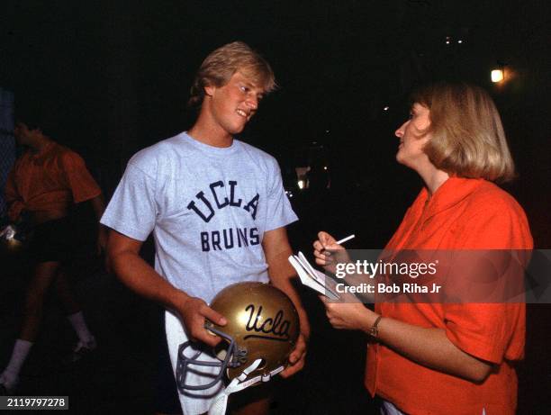 Los Angeles Times Sports Reporter Tracy Dodds talks with University of California Los Angeles Quarterback Rick Neuheisel after practice at Rose Bowl...