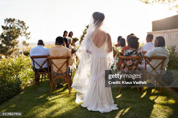 young bride walking aisle amidst guests - cérémonie du mariage photos et images de collection