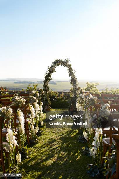 chairs decorated with flower near wedding altar - destination wedding stock pictures, royalty-free photos & images
