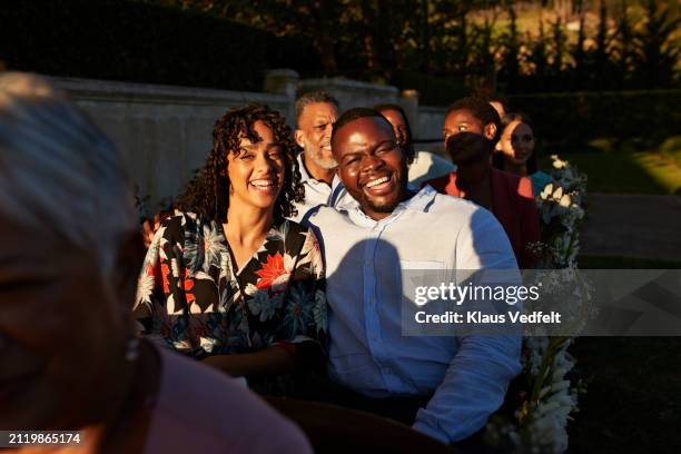 cheerful young couple sitting with wedding guests - 70s wedding black couple stock pictures, royalty-free photos & images