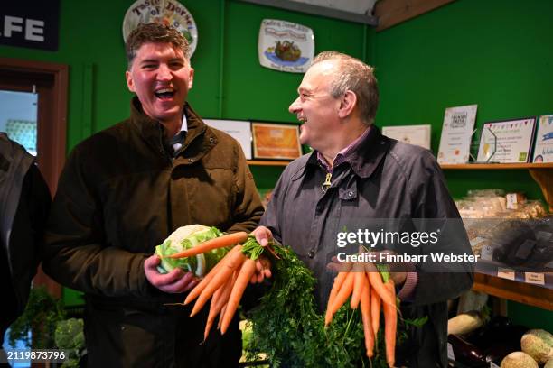 Liberal Democrats Leader Ed Davey holds some carrots alongside Lib Dem parliamentary candidate for West Dorset, Edward Morello at Washingpool...