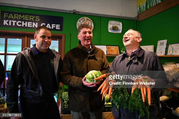 Liberal Democrats Leader Ed Davey holds some carrots alongside Lib Dem parliamentary candidate for West Dorset, Edward Morello and owner of the farm...