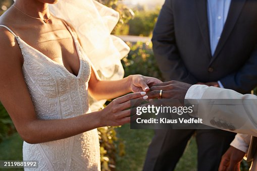 Young bride exchanging wedding ring with groom Young bride exchanging wedding ring with groom