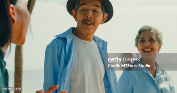 asian senior adult couple is guided by a local female guide while traveling on vacation. happy elderly people enjoy the lifestyle after retirement. - mes stock pictures, royalty-free photos & images