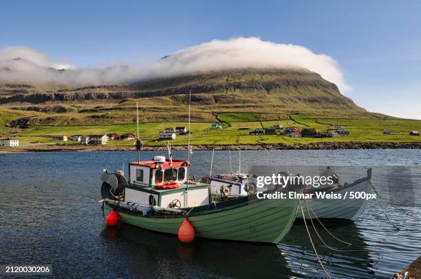 scenic view of boats in sea against sky,faeroe islands,denmark - faroe islands stock pictures, royalty-free photos & images