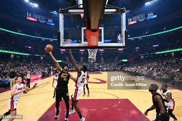 Jarrett Allen of the Cleveland Cavaliers shoots over Thomas Bryant of the Miami Heat during the first half at Rocket Mortgage Fieldhouse on March 20,...