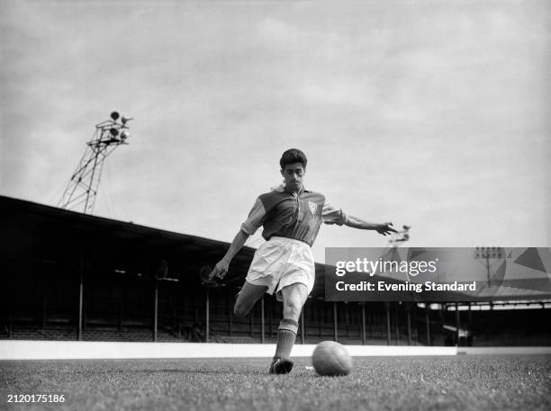 West Ham Football Club striker Harry Hooper kicking a ball at Upton Park, London, December 30th 1955.