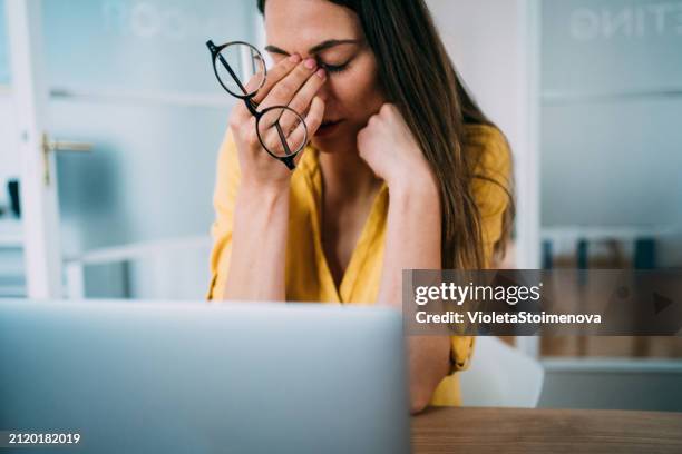 overworked young businesswoman in the office. - being fired stock pictures, royalty-free photos & images