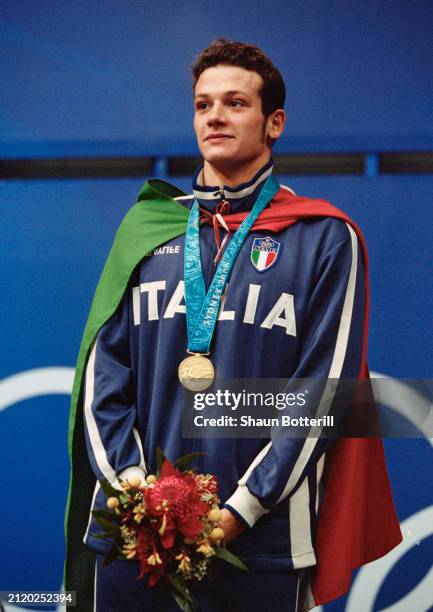 Domenico Fioravanti from Italy stands on the victory podium with his gold medal after winning the Men's 100 metres Breaststroke competition on 17th...