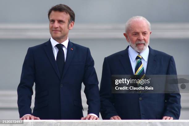 President of France Emmanuel Macron stands next to President of Brazil Luiz Inácio Lula da Silva during an official visit to Brazil at Planalto...