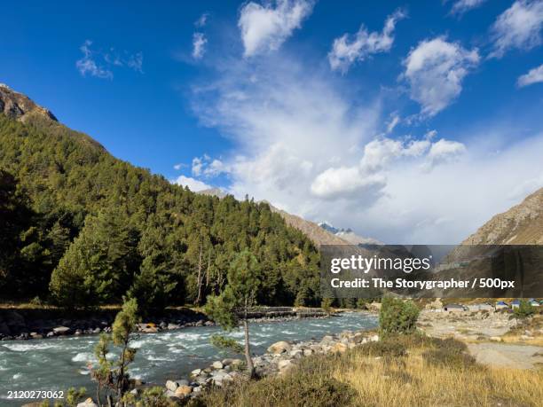 scenic view of river by mountains against sky - the storygrapher fotografías e imágenes de stock