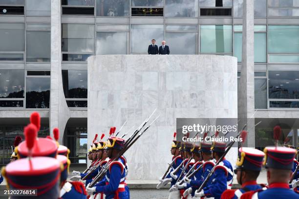 President of France Emmanuel Macron stands next to President of Brazil Luiz Inácio Lula da Silva during an official visit to Brazil at Planalto...