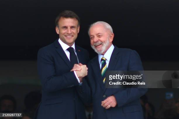 President of France Emmanuel Macron shakes hands with President of Brazil Luiz Inácio Lula da Silva during an official visit to Brazil at Planalto...