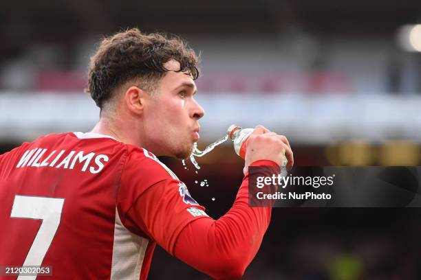 Neco Williams of Nottingham Forest is drinking water and checking results on the LCD board during the Premier League match between Nottingham Forest...