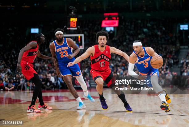 Josh Hart and Mitchell Robinson of the New York Knicks go to the basket against Jordan Nwora and Mouhamadou Gueye of the Toronto Raptors during the...