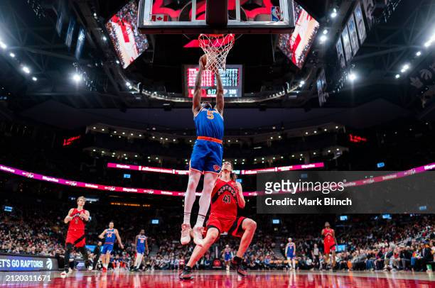 Precious Achiuwa of the New York Knicks dunks against Kelly Olynyk of the Toronto Raptors during the second half of their basketball game at the...