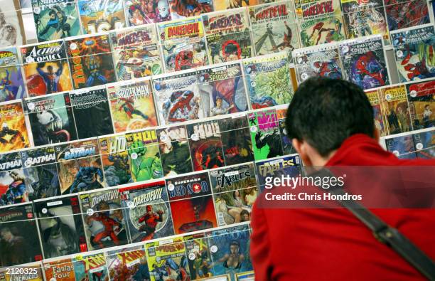 Convention goer looks over a large collection of classic comic books at the Sci-Fi and Fantasy Creators Convention June 27, 2003 in New York City....
