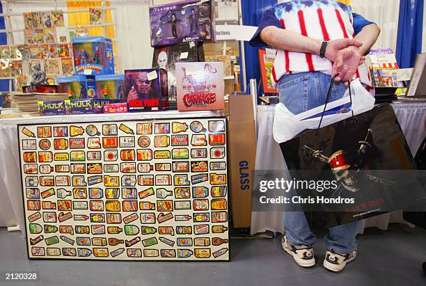 Convention goer looks over collectibles at the Sci-Fi and Fantasy Creators Convention June 27, 2003 in New York City. The convention features...