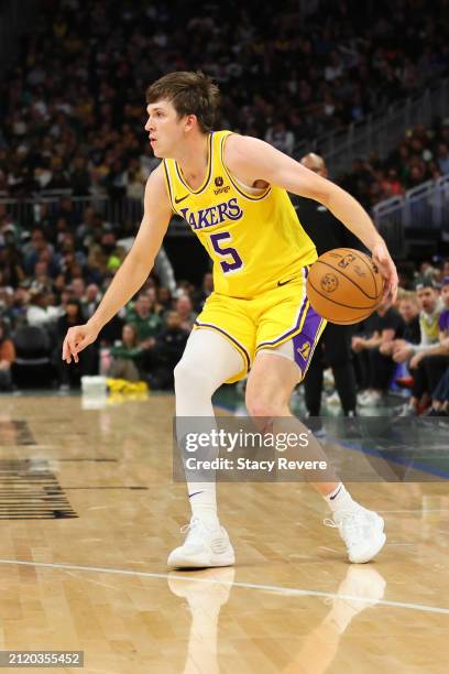 Austin Reaves of the Los Angeles Lakers handles the ball during a game against the Milwaukee Bucks at Fiserv Forum on March 26, 2024 in Milwaukee,...